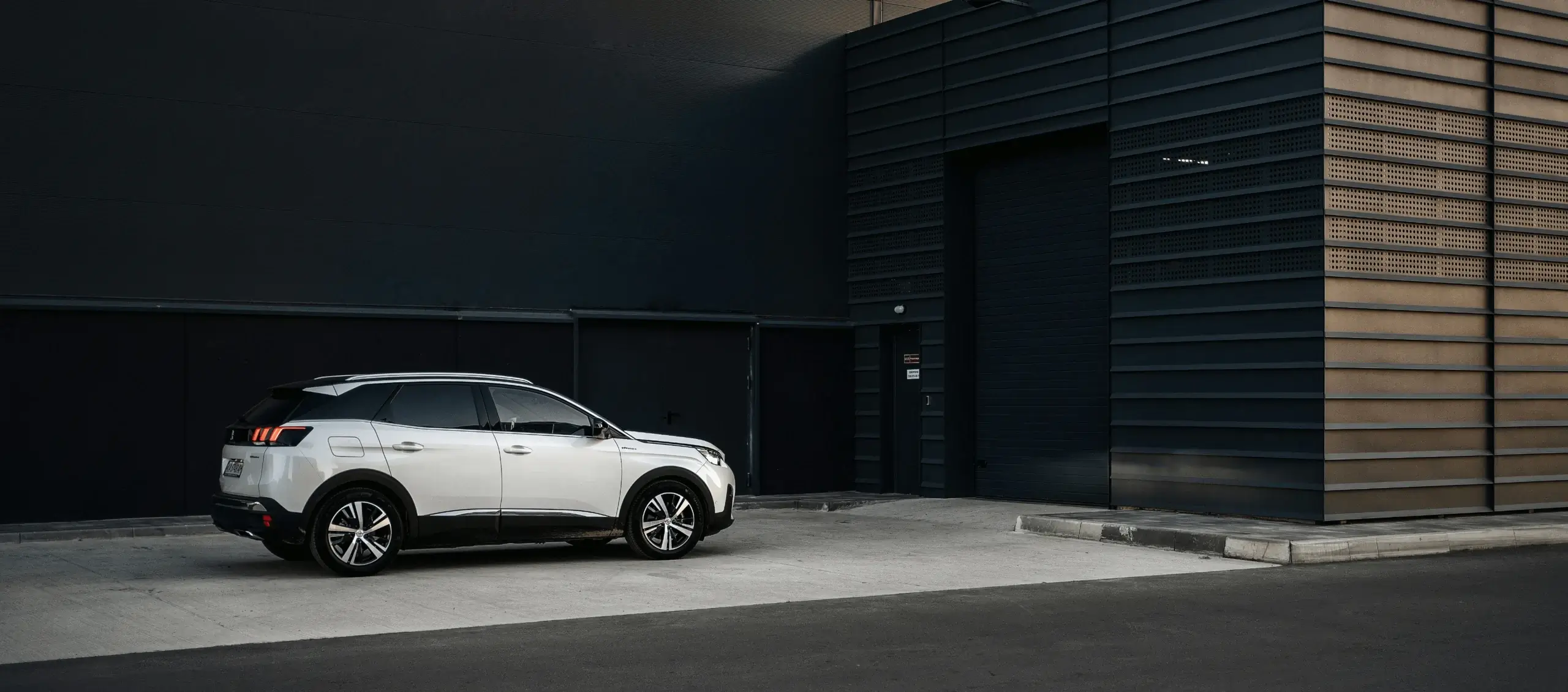 White SUV outside a modern building